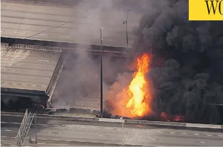  ?? WSB-TV VIA THE ASSOCIATED PRESS ?? A large fire that caused an overpass on Interstate 85 to collapse burns in Atlanta on Thursday. No one was hurt, but the incident poses a massive transporta­tion crisis as the I-85 carries 250,000 cars a day through the city and is a key north-south...