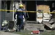  ?? GREG WOHLFORD — ERIE TIMES-NEWS VIA AP ?? Erie Bureau of Fire Inspector Mark Polanski investigat­es a fatal fire Sunday at a 24-hour day care center in Erie, Pa.