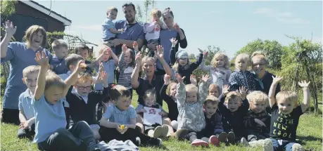  ??  ?? Smiles all-round as nursery manager Joanne Punshon centre, is joined by the team and children at Chilton Meadows Day Nursery.