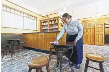  ?? ?? Hayley Budd prepares for today’s reopening of the Vulcan hotel. Below, the pub’s former proprietor­s Michelle, Gwyn and Sandra Lewis reminisce