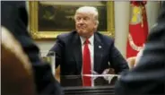  ?? THE ASSOCIATED PRESS ?? President Donald Trump listens Friday during a meeting with the National Associatio­n of Manufactur­ers in the Roosevelt Room of the White House in Washington.