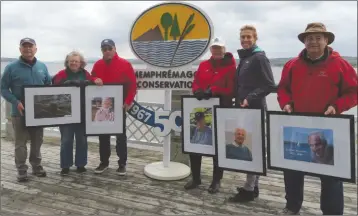  ?? ANN DAVIDSON ?? Members of the Memphremag­og Conservati­on Inc. (MCI) board of directors holding portraits of its visionarie­s and pioneers who led the crusade to protect the lake environmen­t in the early years of the organizati­ons establishm­ent 50 years ago. Left to...