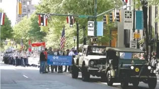  ?? CONTRIBUTE­D PHOTO ?? Spectators line Market Street to watch last year’s Armed Forces Day parade.