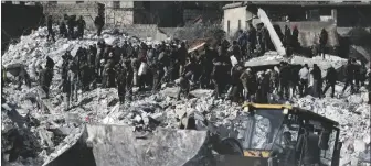  ?? AP PHOTO/GHAITH ALSAYED ?? Rescuers and residents search through the rubble of collapsed buildings in the town of Harem near the Turkish border, Idlib province, Syria, on Wednesday.