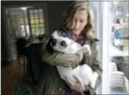  ?? (AP Photo/Steven Senne) ?? In this Wednesday, March 29, 2017 photo Kate Fredette, of Waltham, Mass., holds the family dog Roscoe at their home in Waltham. The Fredette family found the dog through the online platform How I Met My Dog, that matches humans with dogs based on what...