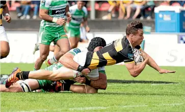  ?? GETTY IMAGES ?? Taranaki halfback Liam Blyde scores his second try against Manawatu¯ yesterday.