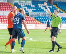  ??  ?? Ross County’s Harry Paton was shown a yellow card.