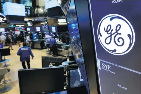  ?? RICHARD DREW/AP ?? The General Electric logo appears above a trading post at the New York Stock Exchange. Boston-based GE’s stock has been in a free fall, closing at the lowest level in five years on Nov. 2, as the firm unleashed sudden changes without a lack of public...