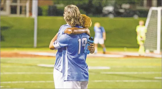  ?? Steven Eckhoff ?? Model’s Dakota Sapp (19) and Kevin Espinoza share a hug after their team’s loss to Toombs County on Wednesday in the Class AA state championsh­ip game.