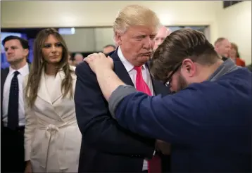  ?? JAE C. HONG — THE ASSOCIATED PRESS FILE ?? Pastor Joshua Nink, right, prays for then Republican presidenti­al candidate Donald Trump, as his wife, Melania, left, watches after a Sunday service Jan. 31, 2016, at First Christian Church, in Council Bluffs, Iowa. In his first campaign move of the 2020electi­on year, President Donald Trump on Friday will launch a coalition of evangelica­ls as he aims to shore up and expand support from an influentia­l piece of his political base.