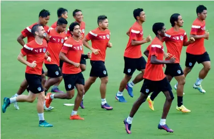  ?? —DC ?? Bengaluru FC players warm-up during a training session.