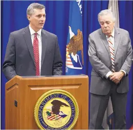  ?? ADOLPHE PIERRE-LOUIS/JOURNAL ?? Special Agent in Charge Terry Wade, left, announces the guilty plea entered by Paul Donisthorp­e, 62, who is charged with embezzleme­nt of $4.8 million from client trust accounts. Acting U.S. Attorney James Tierney, right, joins Wade at the Nov. 27 news...