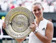  ?? AP ?? Angelique Kerber with the women’s singles trophy after defeating Serena Williams in the Wimbledon final yesterday.