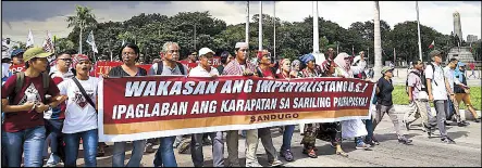  ?? EPA/MIGUEL DE GUZMAN ?? Anti-riot cops stand guard as indigenous people, students and militant groups march toward the US embassy in Manila yesterday. The rallyists protested against the presence of US troops and condemned last week’s violent dispersal which left at least 40...