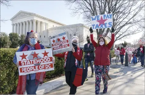  ?? AP photo ?? Advocates for statehood for the District of Columbia rally prior to a House of Representa­tives hearing on creating a 51st state Monday. They were able to gather near the Capitol building after the outer perimeter security fencing was dismantled this weekend.