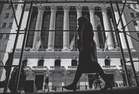  ?? EMILE WAMSTEKER / BLOOMBERG VIA GETTY IMAGES ?? Clockwise from left: A view of the New York Stock Exchange. BRENDAN MCDERMID / FILE PHOTO / REUTERS Traders work on the floor of the exchange on April 7. COLIN ZIEMER / NEW YORK STOCK EXCHANGE VIA AP Bill Hwang (right), founder of Tiger Asia Management, leaves a federal court in Newark, New Jersey, with his attorney Lawrence Lustberg (left) after a hearing in December 2012.