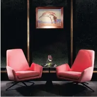  ??  ?? A conversati­on spot with modern pink armchairs and a Pierneef painting.