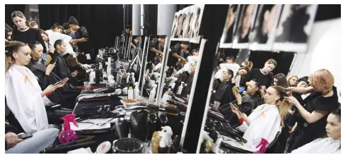  ??  ?? Models get ready backstage for a fashion show by a Chinese designer