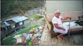  ?? RAMON ESPINOSA / ASSOCIATED PRESS ?? Juana Sortre Vazquez sits on her soaked couch in what remains of her home, destroyed by Hurricane Maria in Morovis, Puerto Rico, on Sept 30.