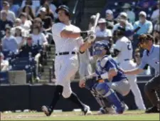  ?? LYNNE SLADKY — THE ASSOCIATED PRESS ?? New York Yankees’ Aaron Judge, left, follows through on a double in the third inning during a spring training game against the Toronto Blue Jays, Monday.