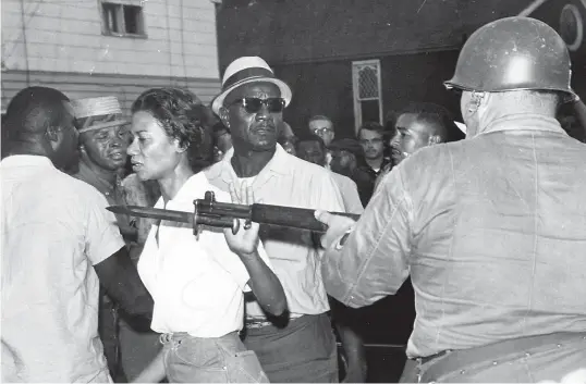  ?? AP ?? Gloria Richardson pushes a National Guardsman’s bayonet aside in July 1963 in Cambridge as she moves among a crowd of African Americans to convince them to disperse.