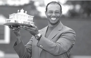  ?? Lucy Nicholson, Reuters/file ?? TIGER Woods celebrates with his green jacket and trophy after winning the 2019 Masters. Woods is targeting the 2020 Olympics as he seeks to add another glittering chapter to his storied career.