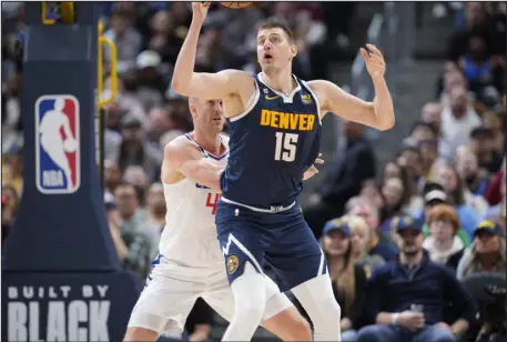  ?? DAVID ZALUBOWSKI — THE ASSOCIATED PRESS ?? Nuggets center Nikola Jokic, front, and is guarded by the Clippers’ Mason Plumlee in the second half of a game last week at Ball Arena.