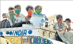  ?? HT ?? Migrants have been travelling like this on roof-tops of trucks, and in more dangerous ways in other vehicles, to reach their homes.