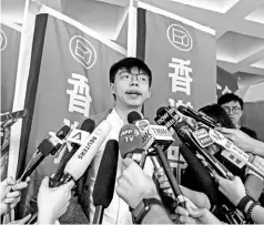  ??  ?? Wong speaking to the media in front of the high court in Hong Kong. — AFP photo