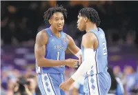  ?? JAMIE SQUIRE/GETTY ?? North Carolina’s Leaky Black, left, and Caleb Love react to a play against Duke during an NCAA Tournament semifinal on April 2. Both will return to the Tar Heels next season.