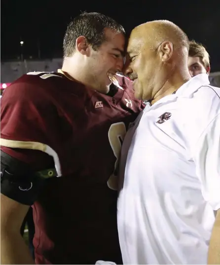  ?? Winslow Townson, Getty Images ?? Steve Addazio and his son, Louie, embrace after Boston College beat USC 37-31 on Sept. 13, 2014, in Chestnut Hill, Mass.