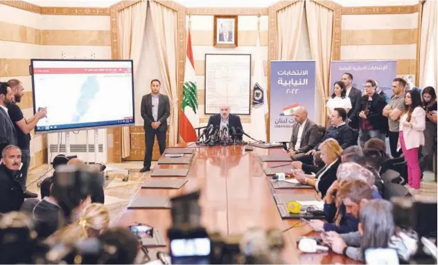  ?? Associated Press ?? ↑
Bassam Mawlawi (centre), speaks during a press conference about parliament­ary elections at the interior ministry in Beirut on Monday.