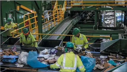  ?? PHOTOS BY ANNE WERNIKOFF FOR CALMATTERS ?? GreenWaste employees in San Jose sort recycling materials. The company has invested more than $10million on new machines and staff.