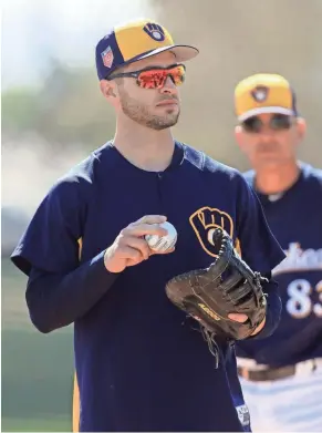  ?? ROY DABNER/SPECIAL TO THE JOURNAL SENTINEL ?? Ryan Braun broke out the first baseman’s glove during the first day of full-squad workouts Tuesday.