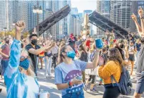  ?? ARMANDOL. SANCHEZ/CHICAGOTRI­BUNE ?? Supporters celebrate nearTrump Internatio­nalHotel& Tower in Chicago after the declaratio­n of victory forPreside­nt-elect Joe Biden on Saturday.