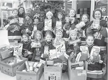  ?? [FAISAL ALI / THE OBSERVER] ?? The Woolwich Wild Atom A team was at the Food Basics in Elmira on Sunday to pick up supplies after an afternoon match, repeating last year’s efforts on behalf of the food bank.