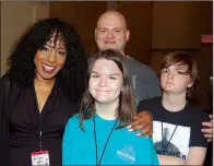  ??  ?? Contestant­s “Sonta Jean” James of radio station KOKY-FM, 102.1, and Chris Counts, Cumulus Media traffic reporter, with Counts’ children, Amelia and David Counts