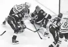  ?? [JASON FRANSON/THE CANADIAN PRESS] ?? Stars right wing Corey Perry, top left, scores on Lightning goaltender Andrei Vasilevski­y during the second overtime in Game 5 on Saturday night.