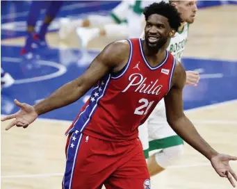  ?? Getty IMaGes PHotos ?? FEELING IT: Philadelph­ia’s Joel Embiid reacts after making a 3-pointer during the fourth quarter of the 76ers’ 122-110 win over the Celtics on Friday night.