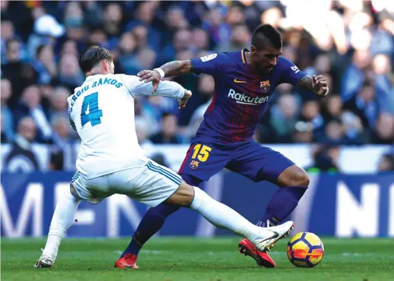  ??  ?? Barcelona’s Paulinho fights for the ball with Real Madrid’s Sergio Ramos