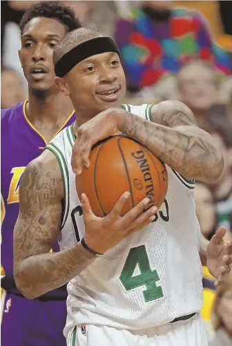  ?? STAFF PHOTO BY STUART CAHILL ?? WELL IN HAND: Isaiah Thomas, who had another huge game with 38 points, protects the ball during the Celtics’ 113-107 victory against the Lakers last night.
