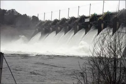  ?? The Sentinel-Record/Grace Brown ?? BALANCING ACT: Entergy Arkansas Inc. releases thousands of cubic feet of water per second from Carpenter Dam into Lake Catherine on Wednesday to maintain the level of Lake Hamilton, which forms behind the dam. Further downstream, Entergy was also...