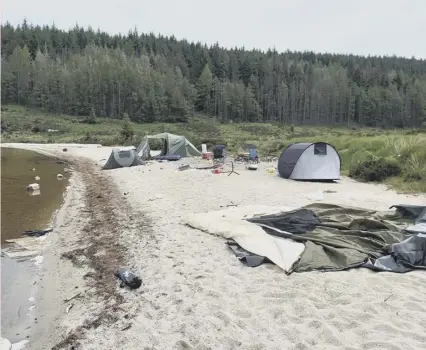  ??  ?? 0 A photo issued by Forestry and Land Scotland of abandoned tents at Loch Grannoch, Dumfries and Galloway