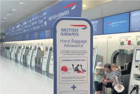  ??  ?? The British Airways check-in desk at Gatwick Airport is almost deserted yesterday as all flights were cancelled