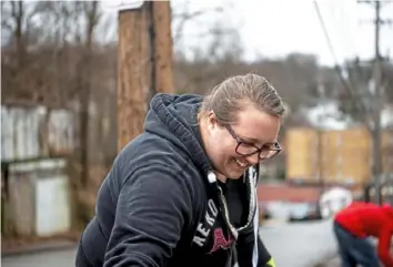  ??  ?? Aimee Wysocki, a founding member of Sheraden Neighbors, helps brighten her neighborho­od.