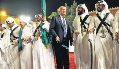  ?? REUTERS ?? Saudi Arabia's King Salman bin Abdulaziz Al Saud (third from left) welcomes US President Donald Trump to dance with a sword during a welcome ceremony at Al Murabba Palace in Riyadh, Saudi Arabia, on Saturday.