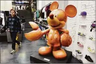  ?? Michael Dwyer / Associated Press ?? “Lobsta Mickey” is displayed in the Concepts sneaker store over the weekend in Boston. The 700-pound statue of Mickey Mouse with giant lobster claws for hands.