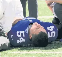  ?? AP ?? WHAT A PAIN: Blake Martinez lays on the turf after tearing his ACL on Sunday.