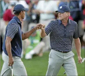  ?? CHARLIE RIEDEL — ASSOCIATED PRESS FILE ?? USA’s Tiger Woods and Steve Stricker celebrate after winning the 16th hole during a fourball match at the Ryder Cup PGA golf tournament in 2012. On Wednesday, Stricker was named a United States’ captain for the 2020 Ryder Cup in hs home state of Wisconsin.