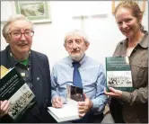  ??  ?? Patrick F O’Donovan signing copies of his new book on the nation’s schools’ for Máirín Uí Shé(r Ceann Trá and Sr De Sales and Máire Uí Shé.